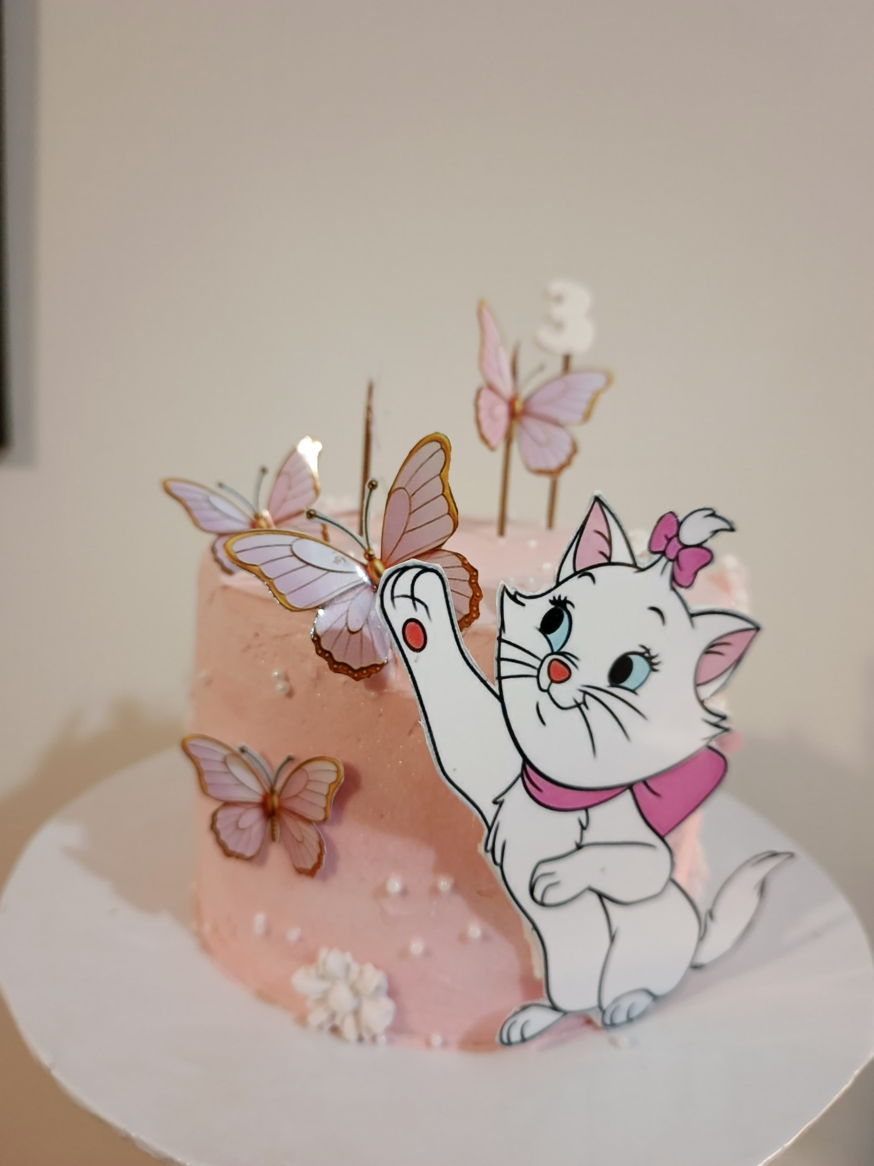 Pink buttercream cake with edible butterflies